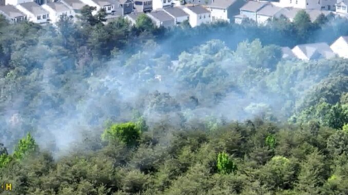 Crews respond to spreading brush fire in Steele Creek area